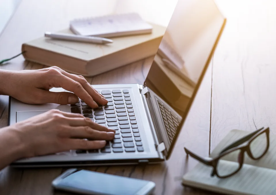 a person typing on a laptop computer at The  Landing At Pleasantdale