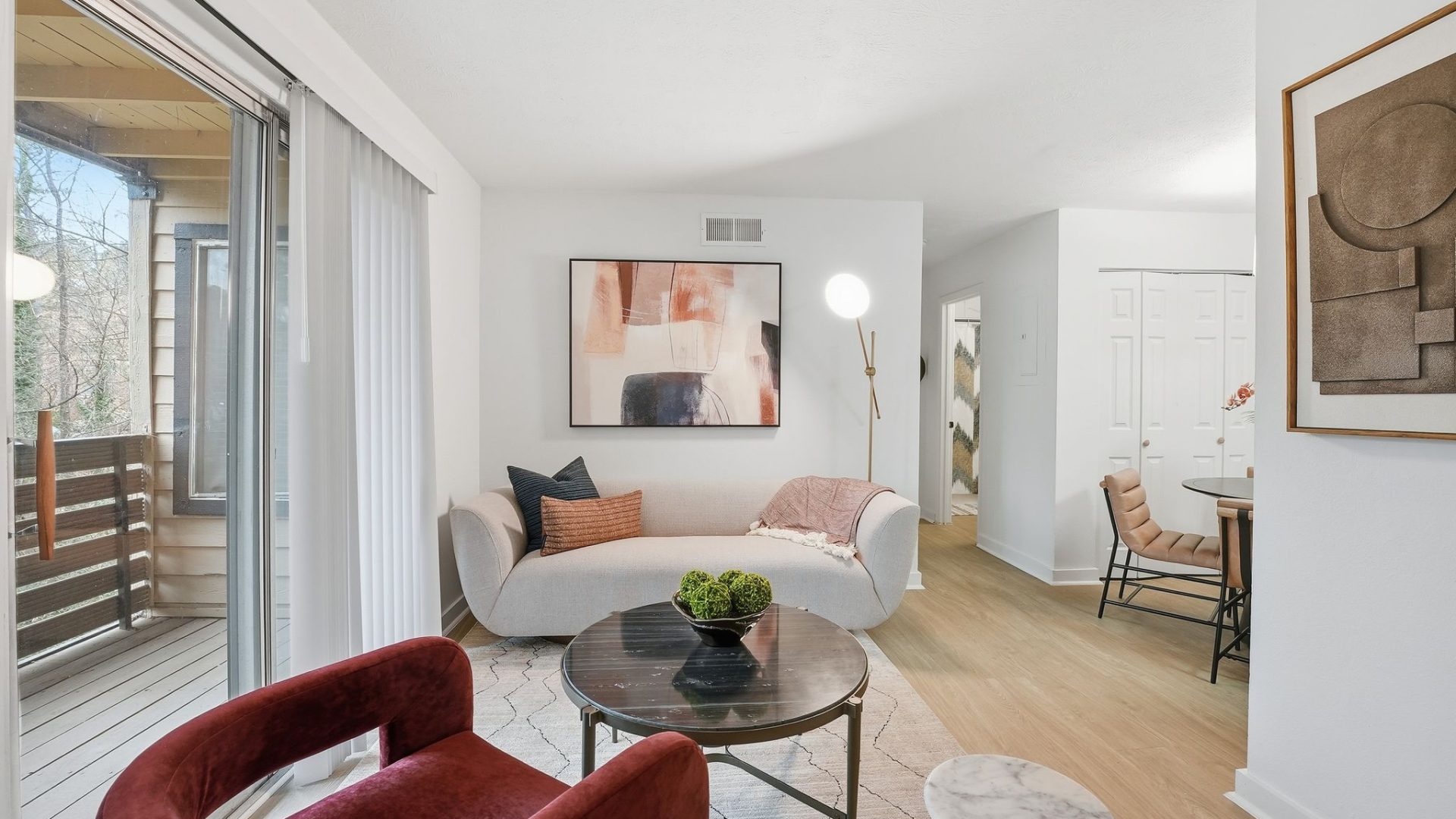 a living room filled with furniture and a large window
