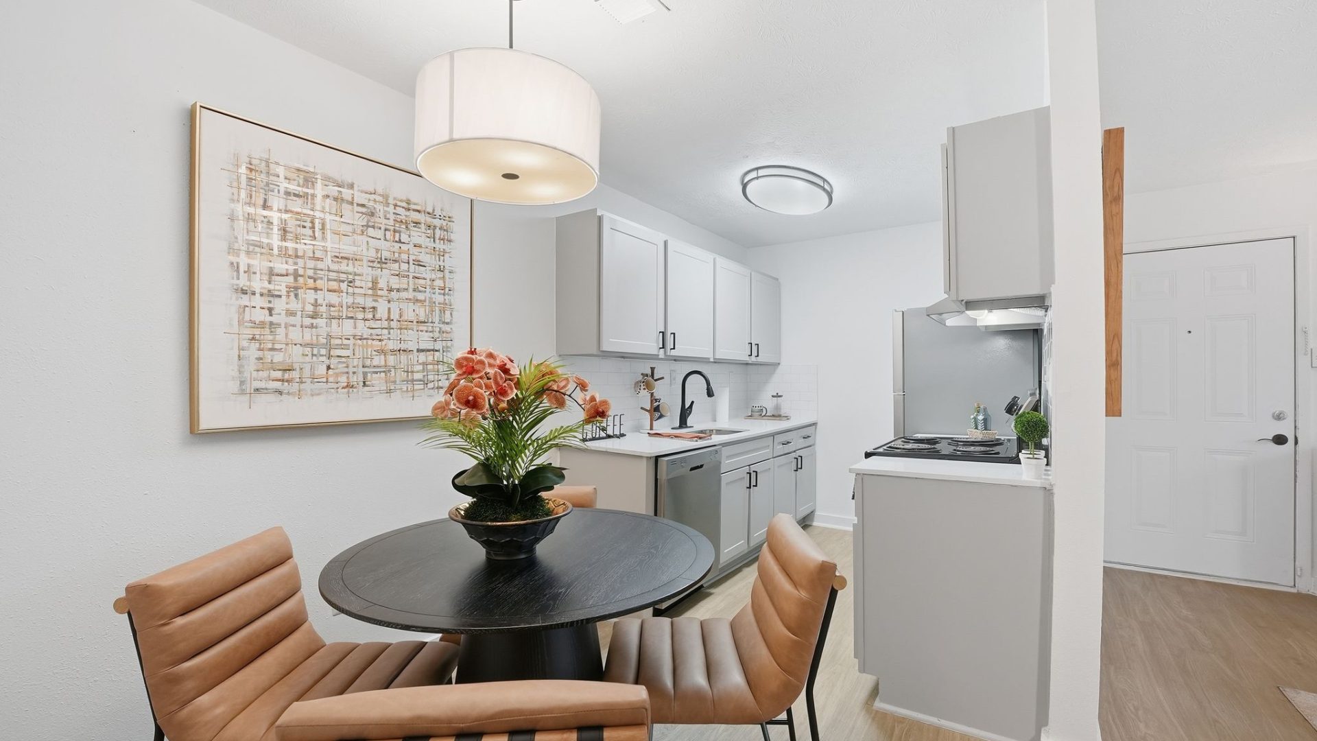 a kitchen with a table, chairs and a refrigerator